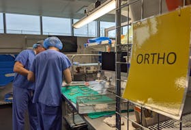 Medical device processing technicians work on a set of orthopedic surgery tools at the Dartmouth General Hospital.