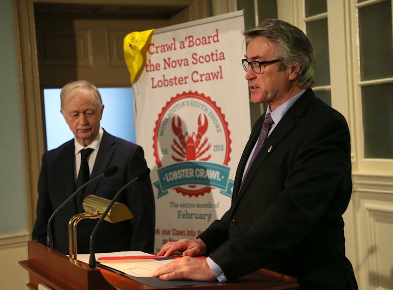 Hugh MacKay, MLA for Chester-St. Margaret's , reads the proclamation announcing that Feb. 28 will be Lobster Day as Fisheries Minister Keith Caldwell looks on at Province House in Halifax on Wednesday, Jan. 29, 2020.
