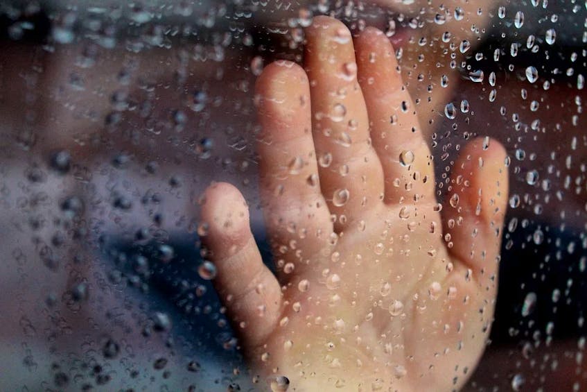 hand at rainy window stock image