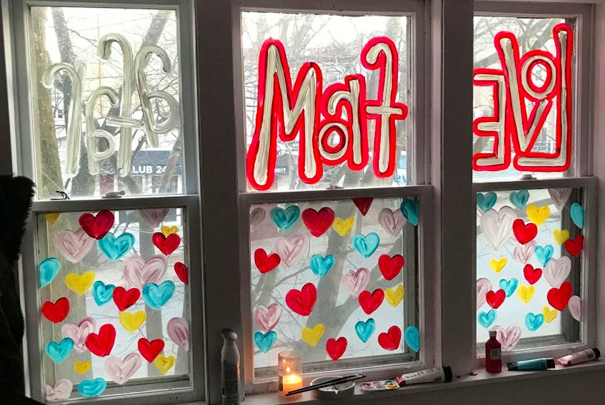 Illustrator Elizabeth Macmichael has painted three windows of her home near downtown Dartmouth to spread the message of Love from Afar. - Elizabeth Macmichael