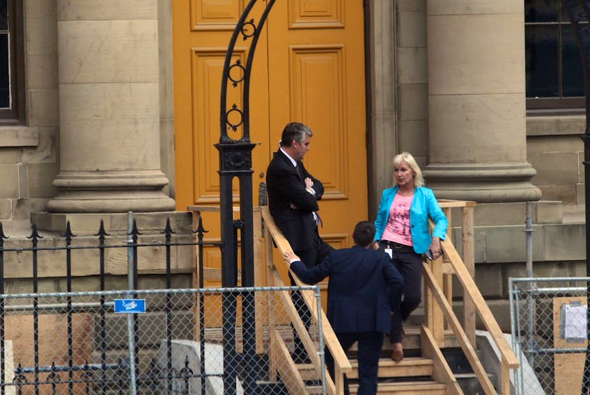 Premier Stephen McNeil, another man and McNeil's principal secretary Laurie Graham talk outside the Granville Street door to Province House on Sept. 26, 2017.