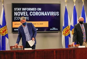 Premier Stephen McNeil and Dr. Robert Strang, Nova Scotia's chief medical officer of health, take their seats before the start of their COVID-19 briefing Friday, Nov. 13, 2020.