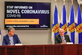 Premier Stephen McNeil listens to Dr. Robert Strang, Nova Scotia's chief medical officer of health, during their COVID-19 briefing Friday, Nov. 13, 2020, in Halifax.