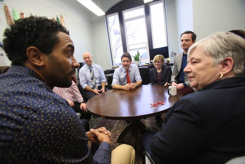 Prime Minister Justin Trudeau meets with members of the north-end Halifax community, including Rodney Small, left, director of the One North End Community Economic Development Society. At left is federal Fisheries Minister Bernadette Jordan, MP for South Shore-St. Margarets.