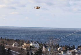 A Cormorant helicopter flies near Parkers Cove, Annapolis County, on Wednesday, Dec. 16, 2020 as part of a search for the missing crew of the scallop boat Chief William Saulis, which went missing early the previous morning.