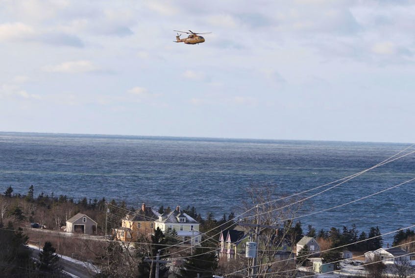 A Cormorant helicopter flies near Parkers Cove, Annapolis County, on Wednesday, Dec. 16, 2020 as part of a search for the missing crew of the scallop boat Chief William Saulis, which went missing early the previous morning.