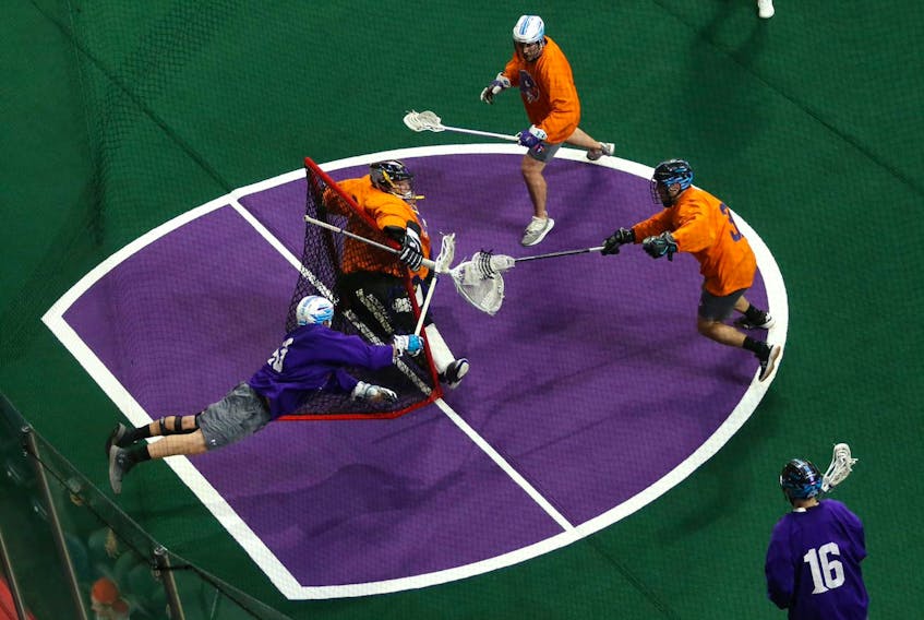 Team Purple's Eric Fannell stretches out on a shot on Team Orange keeper Chase Martin during the Halifax Thunderbirds' Orange vs. Purple game in Halifax Friday, Nov. 22, 2019.