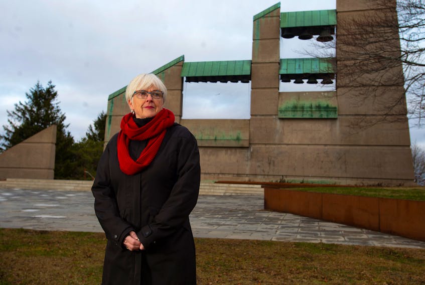 Marilyn Davidson Elliott stands in front of the Halifax Explosion Memorial Bell Tower at Fort Needham Park on Wednesday. Davidson Elliott and some other family members of Explosion survivors will be wearing red scarves at Friday's memorial ceremony.