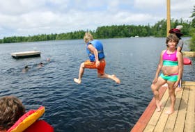 Xavier Korvela of Saint John's is airborne during his leap into the water at the Arthritis Society's summer camp at Camp Brigadoon in July 2015.