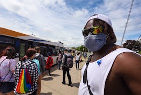 Halifax Transit passengers, many wearing masks, wait to board a bus at the Mumford Road terminal in west-end Halifax on Friday, July 17, 2020. The Nova Scotia government on Friday announced that it was making it mandatory to wear a non-medical mask on public transportation beginning July 24.