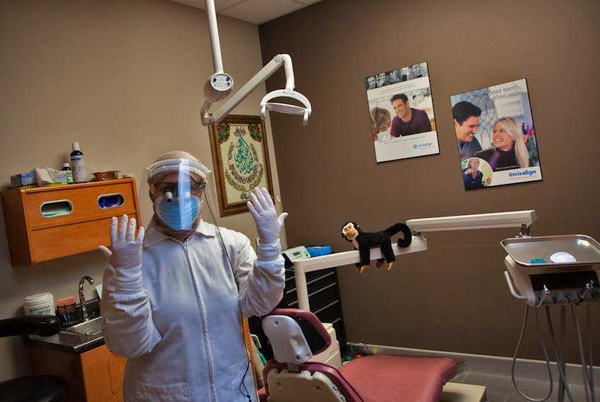 Dr. Sura Hadad is preparing to reopen her Clayton Park dental practice in Halifax. She was wearing protective gear on Wednesday, June 3, 2020 to get used to it.