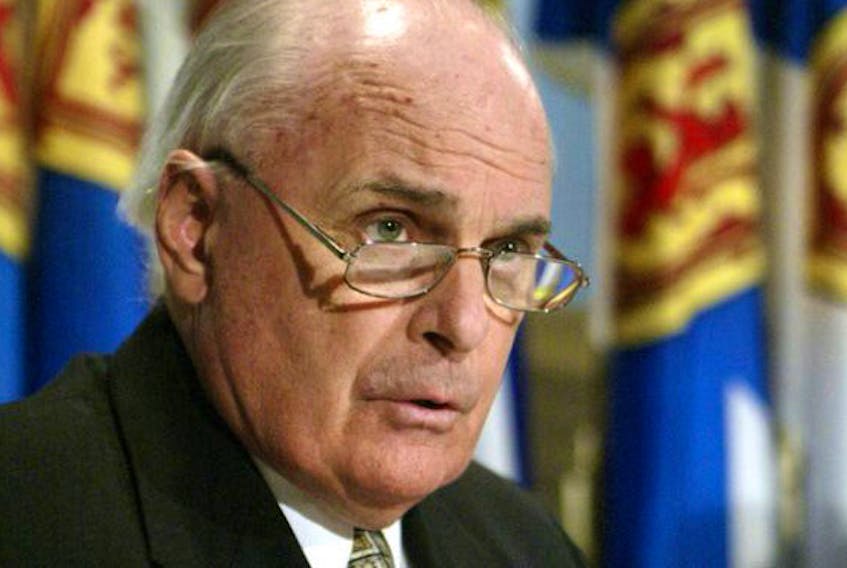 Liberal health critic Dr. Jim Smith answers a question in 2003 during a NSGEU news conference at Province House in Halifax.