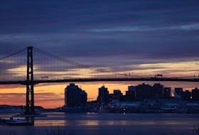 The sun rises behind the Angus L. Macdonald bridge and Halifax skyline on a cold Friday morning, Jan. 10, 2020.