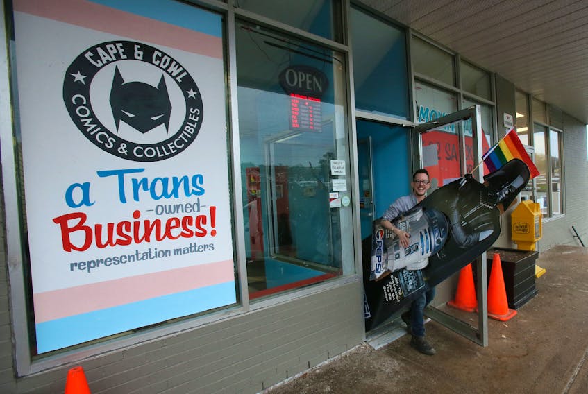 Jay Aaron Roy, the owner of Cape and Cowl Comics & Collectibles in Lower Sackville, carries a cardboard cutout of Star Wars character Darth Vader carrying a gay pride flag during moving day at his store on Monday, Dec. 9, 2019. Roy is moving Cape and Cowl closer to the Lower Sackville library at 622 Sackville Dr.,  and the new location will open Saturday.