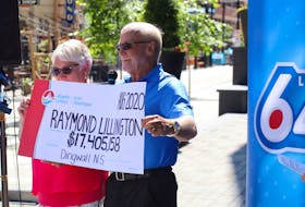 Raymond and Gaye Lillington pose with their ceremonial cheque outside the Atlantic Lottery Corp. offices in downtown Halifax on Wednesday, Aug. 19, 2020 after claiming the $17.4 million prize in the Aug. 15 Lotto 6-49 draw. The Dingwall, N.S., retirees previously won the $3.2 million Lotto 6-49 jackpot in 2013.