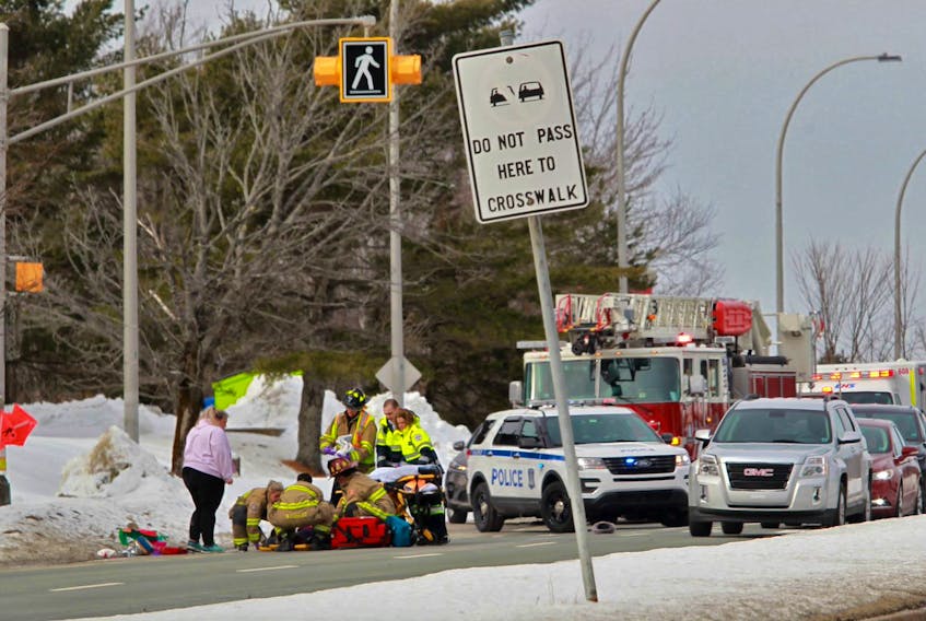 Halifax firefighters and EHS paramedics attend to a pedestrian who was struck in a marked crosswalk on Dunbrack Street at Clayton Park Drive in Halifax Tuesday afternoon, Feb. 18, 2020.