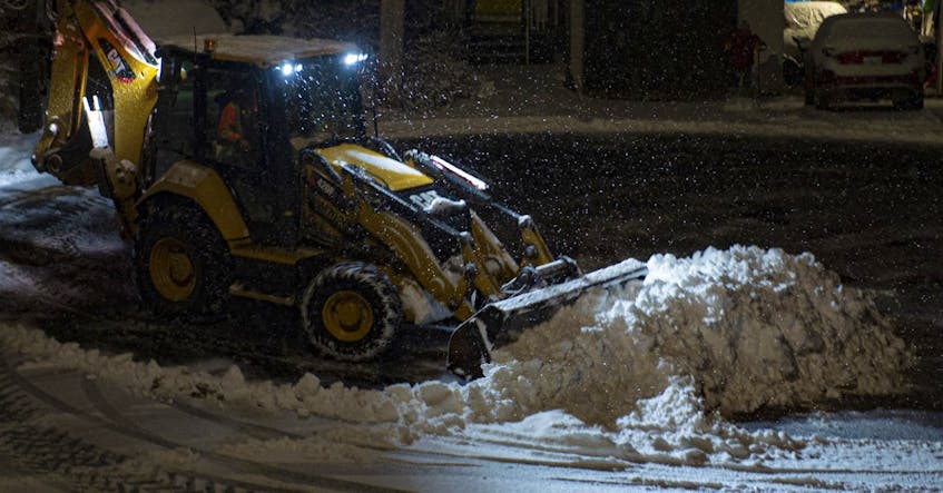 A plow clears a Halifax street as snow continues to fall early Wednesday morning, Dec. 18, 2019.