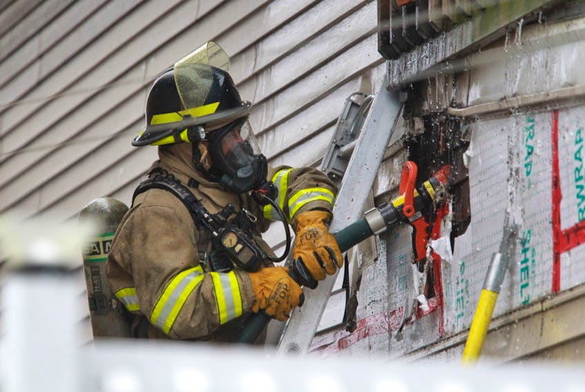 A firefighter works at the scene of a house fire in the 7000 block of Chebucto Road, near the Armdale roundabout, early Tuesday afternoon, March 3, 2020.