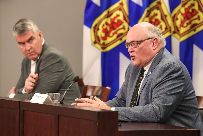 Premier Stephen McNeil listens as Dr. Robert Strang, Nova Scotia's chief medical officer of health, speaks at a COVID-19 news briefing Friday, Nov. 20, 2020.