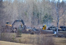 Firefighters work at the scene of a burnt-out home on the Hunter Road near Wentworth, where multiple people are suspected to have been killed by Gabriel Wortman.