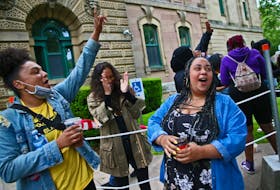 Santina Rao, right, and her supporters Kate Macdonald, left, and El Jones cheer, as a passing vehicle honks in support, after she  spoke to the media  outside the Halifax provincial courthouse on Spring Garden Road in Halifax on Tuesday, July 8, 2020.