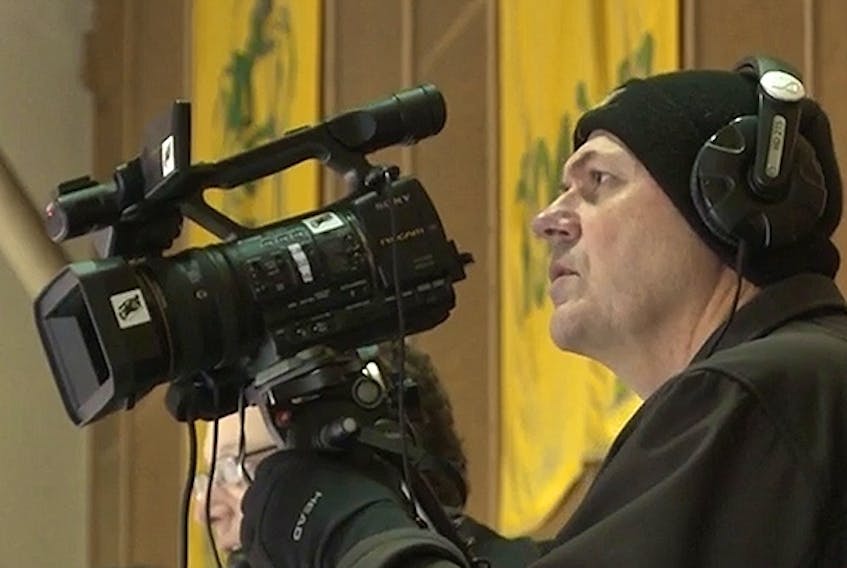 Rob Zittlau films a University of Alberta hockey game at Clare Drake Arena in this undated file photo taken over the last decade. On Sunday, he and his wife, Grace, died in a highway collision near Legal, Alta.