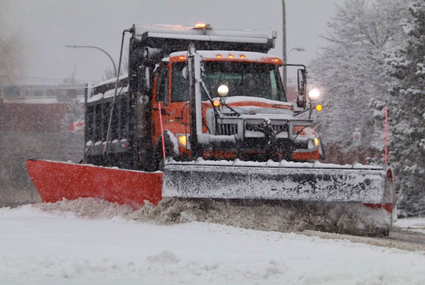 A plow works to clear snow in Halifax on Wednesday, Jan. 8, 2020 as a storm wallops Nova Scotia.