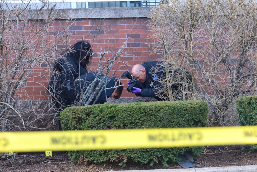 Forensic officers from Halifax Regional Police gather evidence at the scene after a man fell from an apartment balcony on Carrington Place in Halifax. The man, who had been involved in an altercation with a woman, died in the incident.