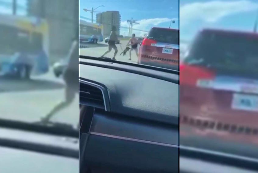 A screengrab from a video that shows a woman swinging a dog by its leash during an altercation in Dartmouth last week.