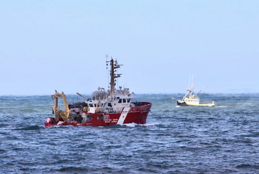 The Canadian Coast Guard Ship M. Perley searches the Bay of Fundy off Hillsburn, Annapolis County, on Wednesday, Dec. 16, 2020 for signs of five missing scallop fishermen or their boat, after the Chief William Saulis went missing early Tuesday morning.