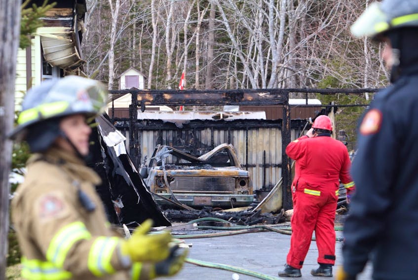 Firefighters investigate after fire caused extensive damage to a home at 2000 Cow Bay Road Tuesday morning, April 7, 2020. There were no injuries.