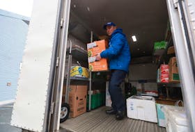 Paul Butler, who works in food distribution with Feed Nova Scotia, brings supplies Thursday afternoon, March 26, 2020 to the kitchen that serves the Metro Turning Point shelter.
