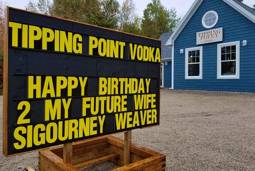 David Blackburn, owner of Tipping Point Distillers in Chester Basin, took advantage of the recent filming of the upcoming film The Good House – and, more specifically, the presence of star Sigourney Weaver – by posting a marriage proposal on his store sign. But while there won’t be any lavish wedding ceremonies, the veteran film star did respond by signing a bottle of vodka from Blackburn’s stock. - Courtesy of David Blackburn, Tipping Point Distillers