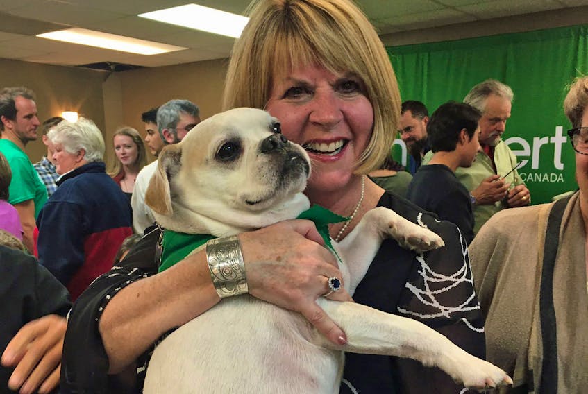 Halifax Green candidate Jo-Ann Roberts gets some puppy love as she's surrounded by a roomful of supporters on election night Oct. 21, 2019 in Halifax. - Ellery Platts