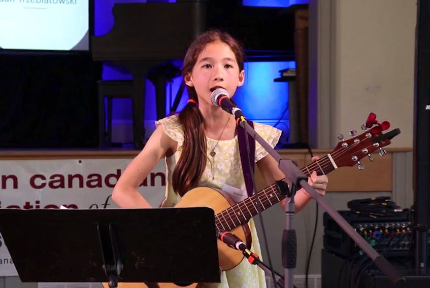 A girl sings Farewell to Nova Scotia as members of the German Canadian Association of Nova Scotia gathered Friday, June 14 for German Settlers Day at the Little Dutch Church in Halifax.