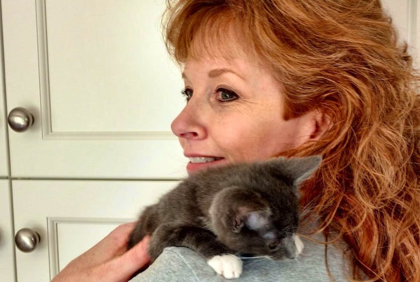 Debbie Saltzman with a rescued special needs kitten called Twiggy, who was born with a twisted leg.