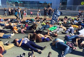 Climate crisis protesters stage a die-in front of Nova Scotia Power headquarters in downtown Halifax on Friday, Sept. 27, 2019.