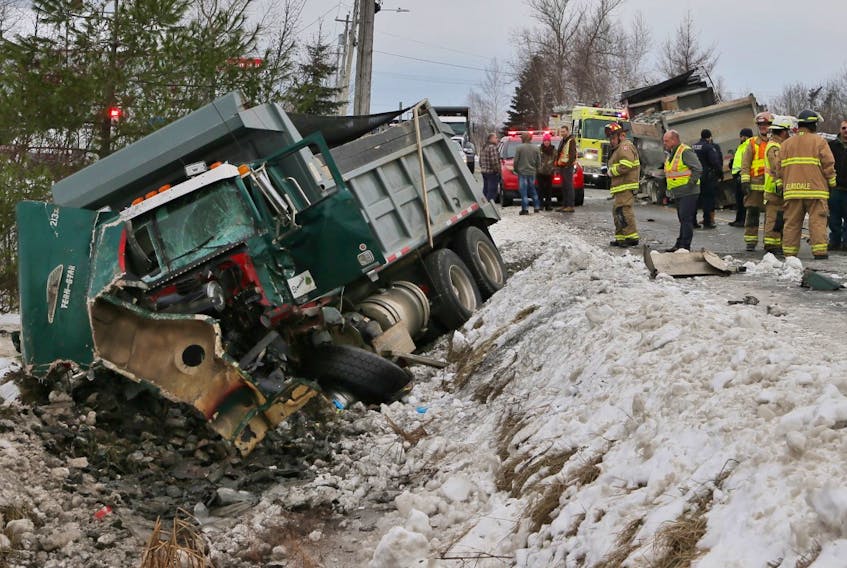 A dump truck with a heavily damaged front end lies in the ditch near 51 Dutch Settlement Road after it was in collision with another dump truck Monday morning, Dec. 2, 2019.