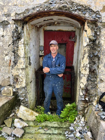 Chris Mills poses in the doorway to the Gannet Rock Lighthouse, south of Grand Manan in the Bay of Fundy, where he had been the lighthouse keeper for two and a half years.