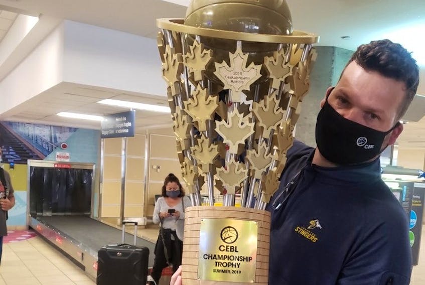 Edmonton Stingers president Brett Fraser arrives at the Edmonton International Airport on Monday, August 10 with the Canadian Elite Basketball League championship trophy in hand after the club won the Summer Series in St. Catharines, Ont. (Supplied/Edmonton Stingers)