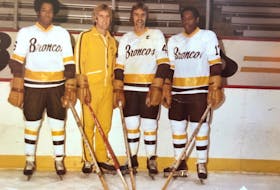 John Saunders (left),  Neil Smith (third from left) and Bernie Saunders (right) at 
Western Michigan University.