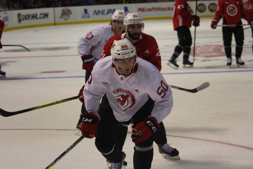 Viktor Loov, front, Kyle Palmieri and Blake Coleman go for the puck during the New Jersey Devils pre-game skate at Credit Union Place.