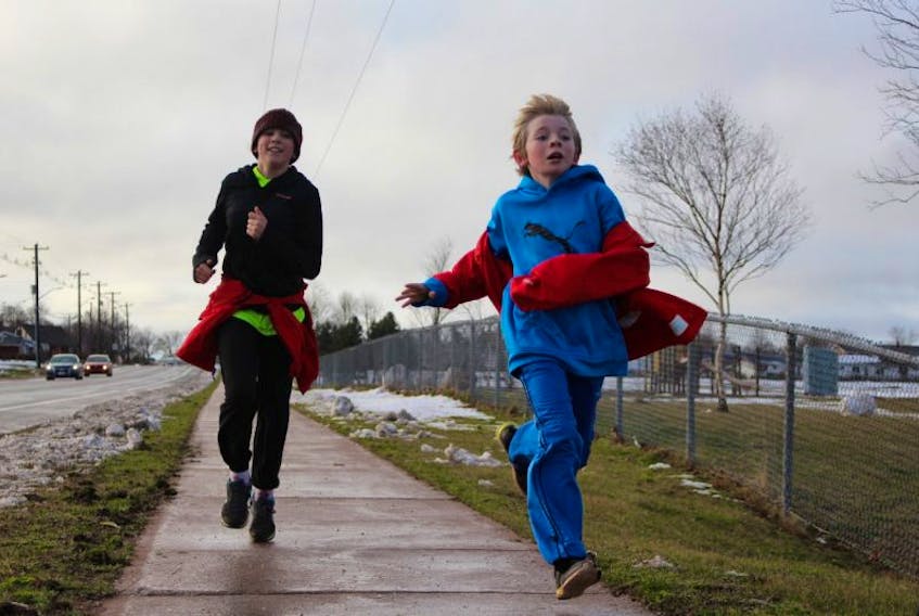 Deirdre Studer and Campbell McNeill run to the finish line of the 5th annual Reindeer Run that took place in Summerside on Saturday.
