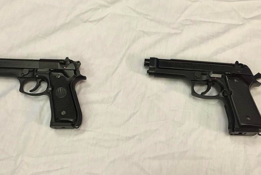 FILE - This April 28, 2016, file photo shows a semi-automatic handgun, left, next to a Powerline 340 BB gun, right, displayed during a news conference in Baltimore. A Manitoba judge is calling for new rules governing imitation firearms, in order to reduce the risk of fatal shootings involving police and so-called suicides-by-cop.