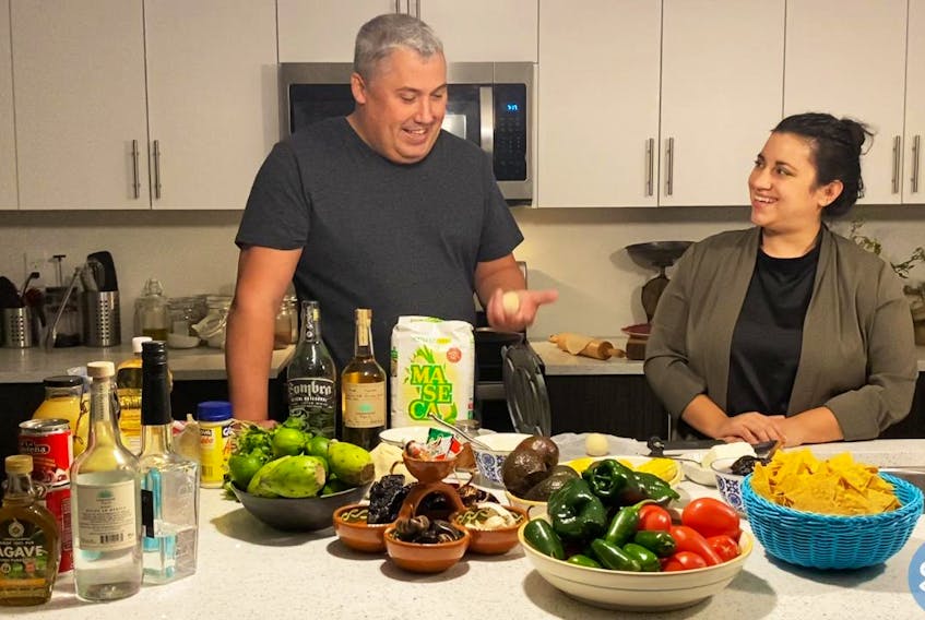 Mark DeWolf (left) and Ana Correa talk - and prepare - a Mexican meal.