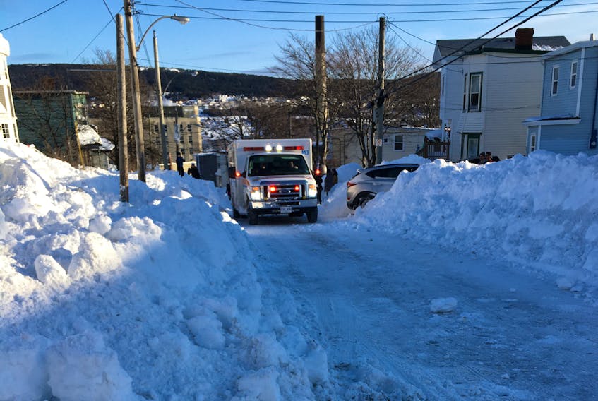 An ambulance with flashing lights in centre city St. John's Sunday, which had to wait for a vehicle to move out of its way. Eastern Health says it’s imperative for non essential traffic to obey the state of emergency rules.
