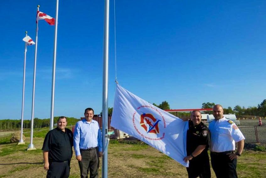 Pictured here at the Canadian Volunteer Fire Services Association flag raising ceremony are, from left, Cpt. Bill Hazel (Hantsport Fire Department) Burnell Lyons (store manager of Sweetgrass Convenience) Deputy Fire Chief Paul Maynard (Hantsport Fire Department and a CVFSA director) and Chief Todd Crowell (Wolfville Fire Department).