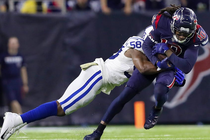 DeAndre Hopkins  of the Houston Texans is tackled by Bobby Okereke of the Indianapolis Colts after a catch in the fourth quarter at NRG Stadium on Nov. 21, 2019 in Houston, Texas.  (Tim Warner/Getty Images)