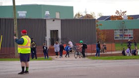 Parents pick up students at West Royalty Elementary School. A funding announcement has raised questions about politicization about expected improvements to the school.