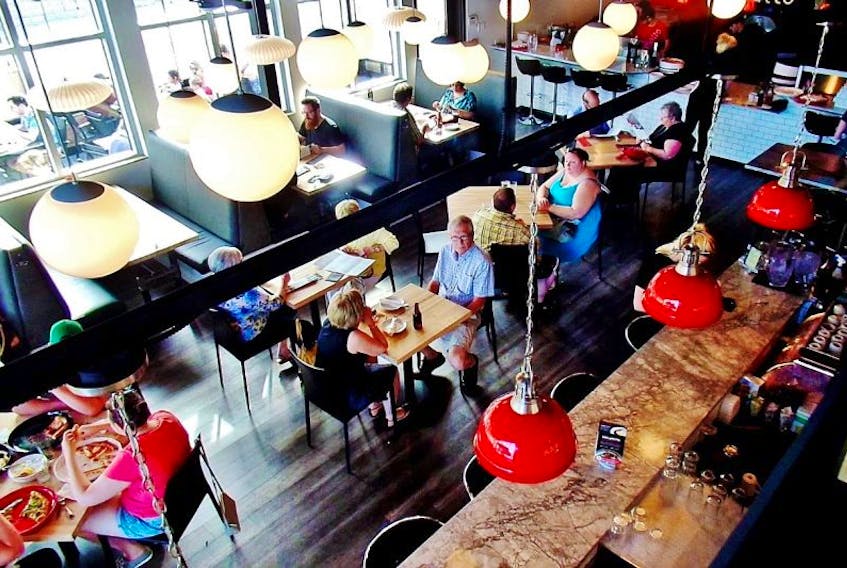 The bright and spacious dining area located at Piatto’s on Elizabeth Avenue.